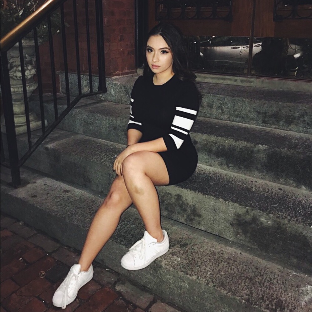 Black knit mini dress with white striped sleeves